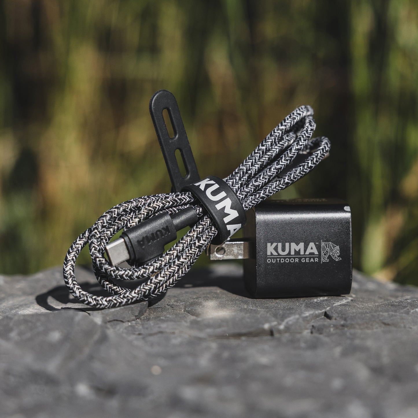 Kuma outdoor gear device with braided cable on a natural background