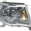 A Toyota Tacoma passenger side replacement headlight assembly with a clear lens and chrome-plated housing.
