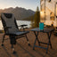 Kuma Off Grid Chair, Cub Bear Compact Folding Table, and KAILANI LANAI Tumbler arranged at a comfortable RV campsite.