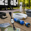 RV surge protector, water filter, and pressure regulator protecting an RV at a campground utility connection.