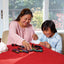 Qwirkle game set with wooden tiles played by mother and child
