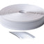 Roll of white trim molding insert with a piece peeled off on a white background