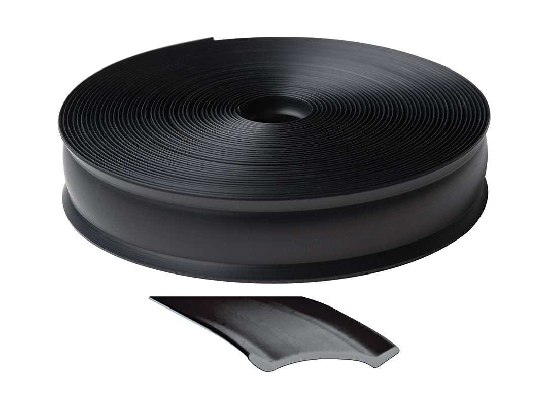 Roll of black trim molding insert with a small piece cut off on a white background