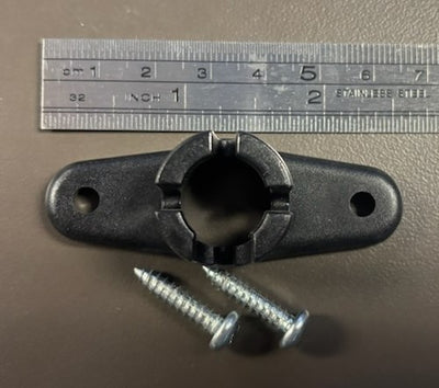 A black metal bracket with a hole in the center and two screws placed next to it, with a ruler for scale in the background.
