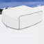 White snowmobile cover on a snowy landscape with mountains in the background