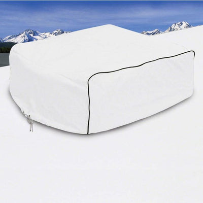 White snowmobile cover on a snowy landscape with mountains in the background