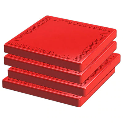 A stack of four red square RV stabilizer pads with grooved surfaces.