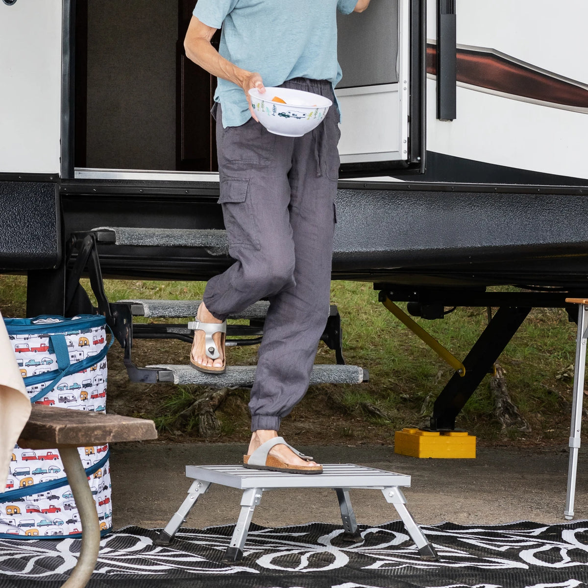 Person using a step stool to enter an RV