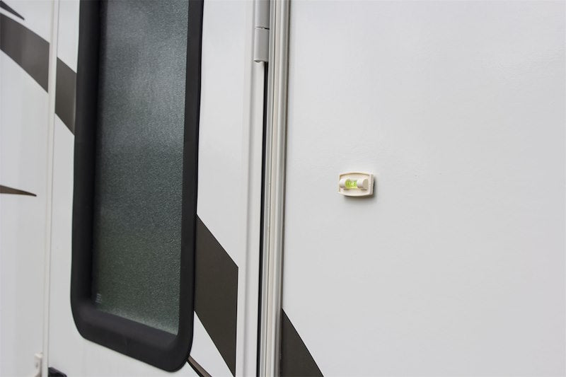 Close-up of a vehicle door with a window and handle on a white background