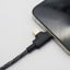 KUMA micro USB cable connected to a smartphone on a light gray background