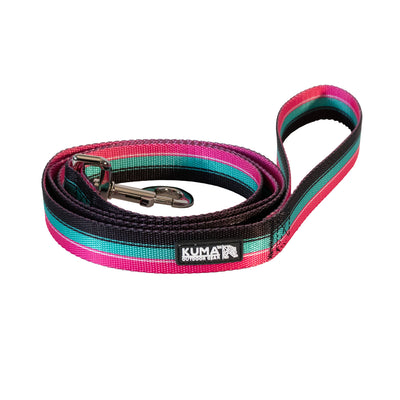 A colorful, retro-inspired dog leash with soft-touch webbing and a metal hook clip. The leash features stripes in multiple colors and has a label with 'KUMA' brand name on it.