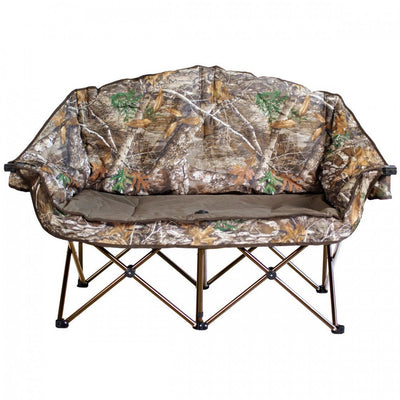 Kuma Bear Buddy Double Chair in Realtree Camo set up at a campsite, heavy‑duty double camping chair with 500 lb capacity designed for RV and outdoor use in Canada