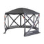 A gray Kuma Bear Den Gazebo with mesh walls and a solid roof set up outdoors.