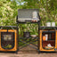 Outdoor camping stove with cabinets and supplies in a forest setting