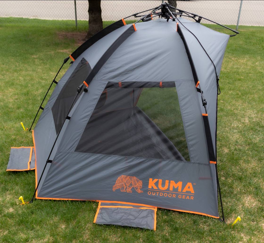 Kuma Keep It Cool shelter secured with stakes outdoors
