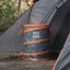 Kuma outdoor gear trash can next to a tent in a forest setting