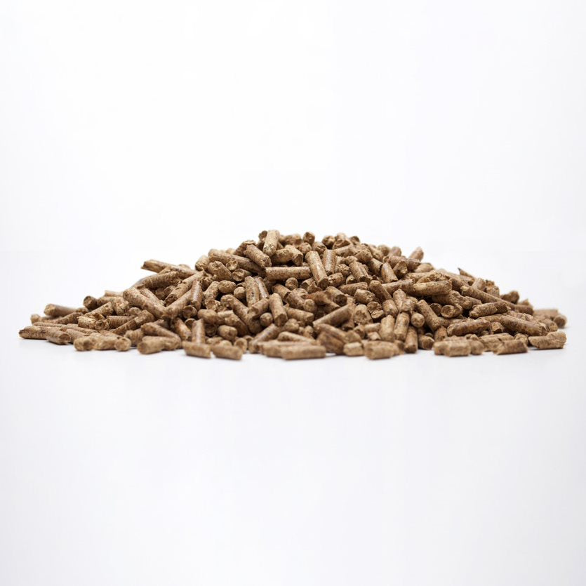 Pit Boss Whiskey Blend hardwood pellets in a pile on white surface
