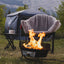 Camping scene with a fire pit, chair, and tent in a natural setting