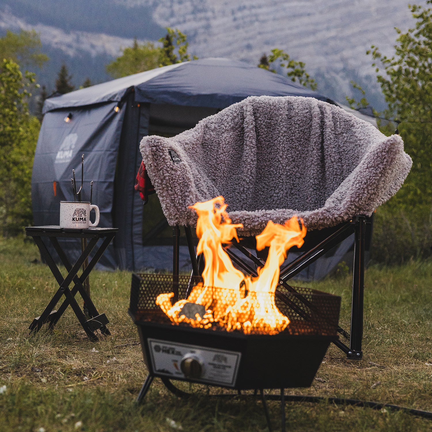 Camping scene with a fire pit, chair, and tent in a natural setting