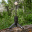 Portable light on a tripod with a forest background