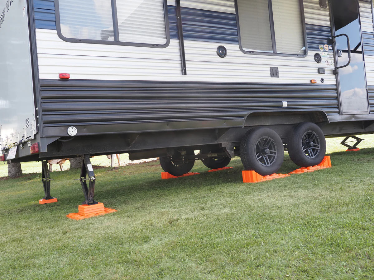 Stacked Tri-Lynx leveling blocks under RV tire
