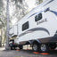 Stacked Tri-Lynx leveling blocks under RV tire
