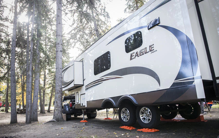 Stacked Tri-Lynx leveling blocks under RV tire

