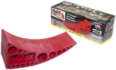 A red-colored Andersen Rapid Jack, a heavy-duty trailer tire ramp and leveler, displayed alongside its packaging box.