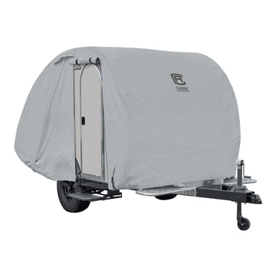 A gray tear drop trailer cover fitted on a tear drop trailer with wheels and a hitch.